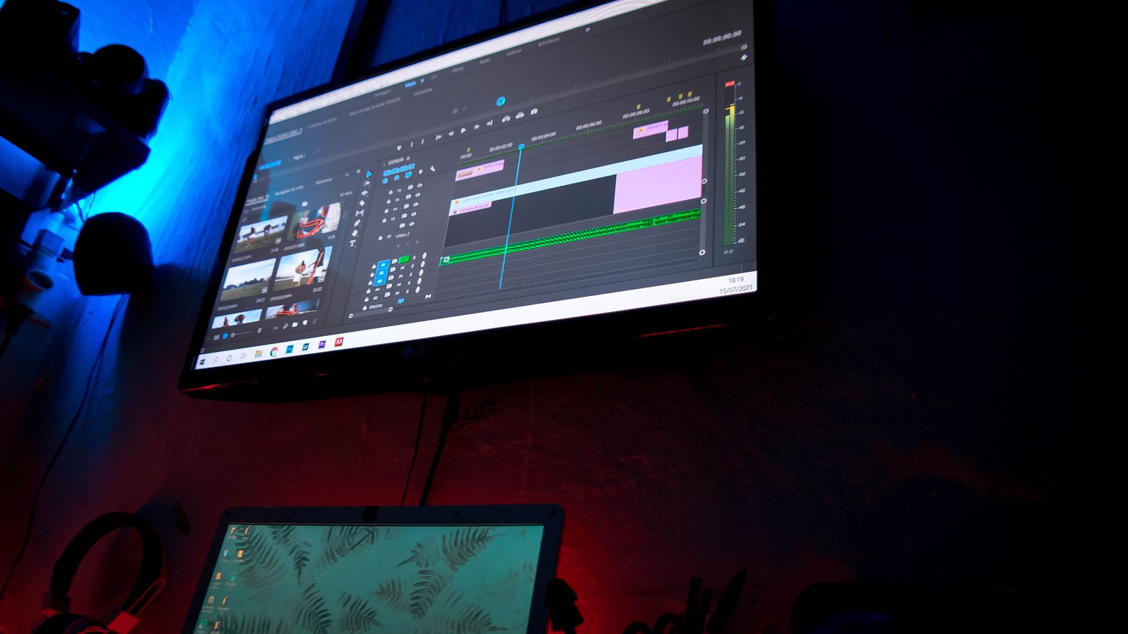 Video editing timeline on a monitor while a finished cinematic clip is exported